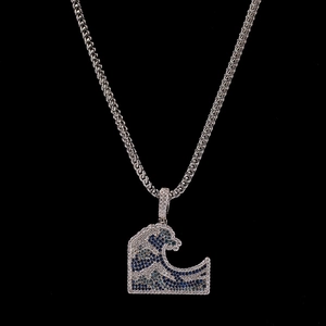 Detailed view of Great Wave pendant with micro-paved blue zircons and silver wheat chain