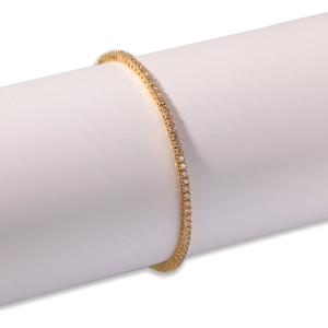 Classic gold tennis bracelet with 2mm round white cubic zirconia stones on display