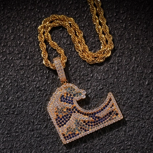 Macro detail of iced-out Great Wave pendant with blue zircons and golden rope chain