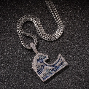 Macro shot of hip hop wave pendant with micro-paved blue and white cubic zirconia