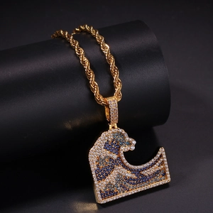 Macro detail of wave pendant with blue and white zircon micro-paving on gold twisted chain