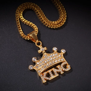 Macro shot of hip hop crown KING pendant with rhinestones on golden cuban chain