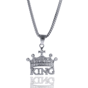 Macro shot of silver hip-hop crown KING pendant with glittering inlaid rhinestones