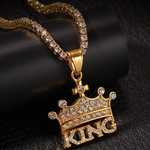 Close-up of hip-hop gold crown KING pendant with rhinestones and tennis chain detail