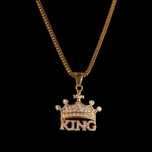 Detailed close-up of hip hop crown pendant with KING letters and sparkling crystals