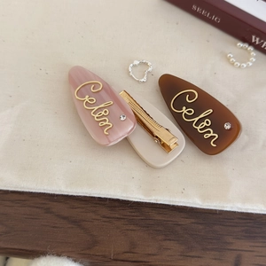 Three-piece French acetate hair clips set with gold lettering and crystal accents