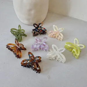 Set of 8 small acetate hollow butterfly hair claws in colorful marble and tortoiseshell patterns