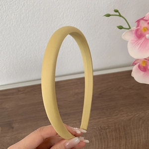 Détail d'un serre-tête rembourré jaune gingembre avec une surface en tissu mat doux