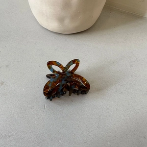 Close-up of tortoise shell pattern acetate butterfly hair claw with hollow design