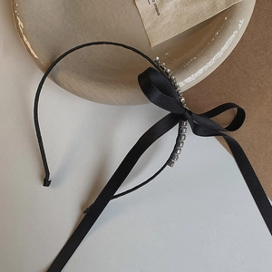 Elegant black ribbon bow headband with shimmering rhinestones and thin metal band