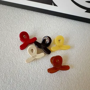 Mini acetate hair claw clips in five colors including cream and amber for styling