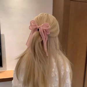 Detailed back view of a pink chiffon ribbon bow banana clip used for a half-up hairstyle