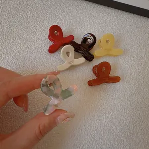 Mini acetate hair claw clips in colorful marbled finishes for women and girls