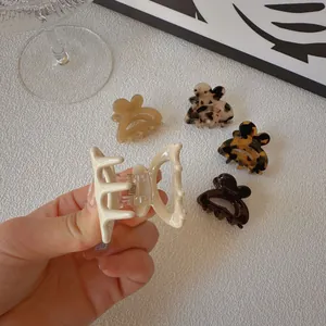 Close-up of elegant acetate butterfly hair claws in five neutral tortoiseshell colors