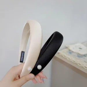 Padded sponge headband with satin finish and single side pearl in black and cream