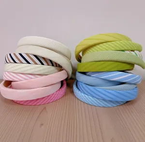 Detailed stack of padded sponge headbands in various solid colors and stripe patterns
