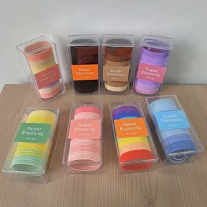Multi-colored high elasticity hair ties set in portable transparent boxes on wood desk