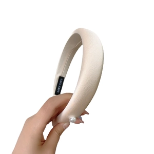 Beige velvet padded headband with single pearl decoration and handmade label