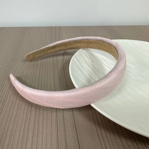 Detail view of pink sponge headband with premium fabric texture and non-slip lining