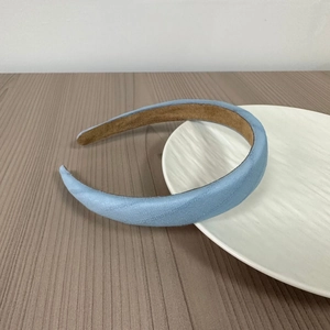 Detail view of light blue padded headband with non-slip brown velvet inner lining