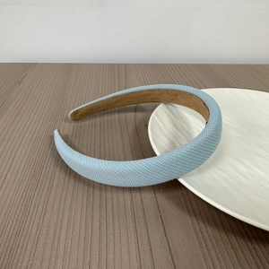 Detail view of light blue knitted headband with non-slip suede lining for comfort