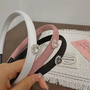 Three elegant handmade heart rhinestone headbands in white, pink, and black fabric