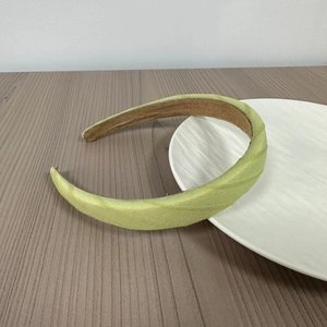 Detail view of light green twill fabric headband with soft brown non-slip velvet inner lining
