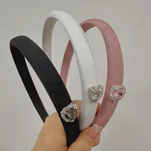 Elegant satin headband with sparkling rhinestone heart decoration available in black and white