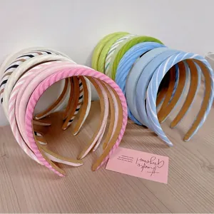 Chic women's pastel hairbands set with twill and mesh textures on wooden background