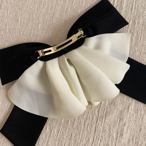 Elegant oversized black satin hair bow with white pleated tulle and gold metal clip