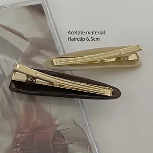 Set of two geometric acetate hair clips in beige and dark brown, length 6.5cm with gold clip