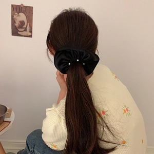 Elegant black satin scrunchie with white pearl detail for high elasticity ponytail hairstyles