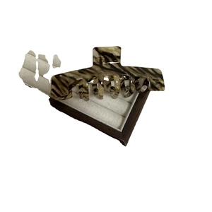Elegant tortoiseshell acetate hair claw clip for bun hairstyles with Barrette La France text