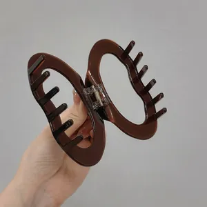 Elegant dark brown cloud-shaped acetate hair claw clip with hollow heart design