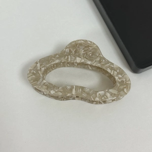 Detailed top view of cream marble acetate cloud hair claw clip for elegant styling