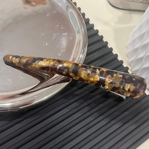 Premium acetate hair clip with dark brown tortoiseshell pattern and handmade metal grip