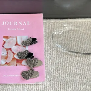 Minimalist heart-shaped rhinestone hair clips in silver finish for women hair styling