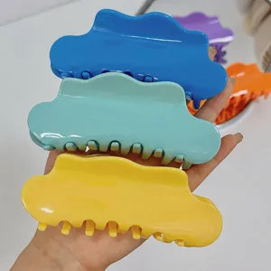 Oversized cloud acetate hair claws in blue green and yellow for thick hair styles
