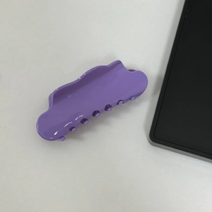 Macro detail of large purple cloud acetic acid hair claw clip for thick hair styling