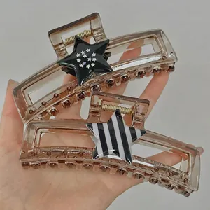 Set of two large brown star hair claws with black and striped star patterns for women