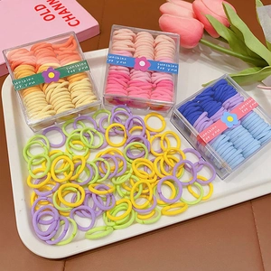 Seamless colorful elastic hair ties for kids in transparent boxes with macaron tones
