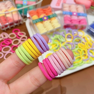 Close-up of high-elasticity candy-colored hair bands for kids on a white tray
