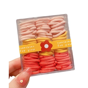 Colorful elastic hair ties for girls in a clear box featuring soft woven texture