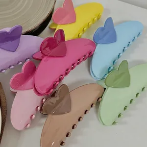 Colorful heart-shaped hair claw clips in various pastel colors on white background