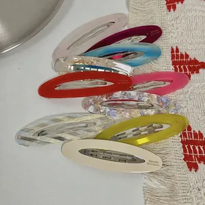 Elegant oval acetate barrettes in various colors with a sleek metallic hair clip base