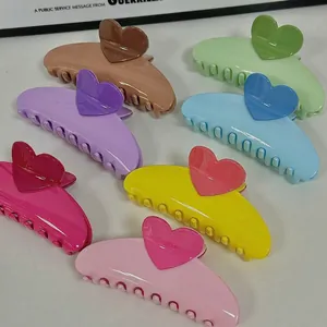 Set of seven cream-colored heart hair claws in vibrant dopamine summer shades