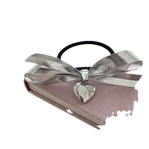 Élastique à cheveux avec nœud argenté et pendentif cœur pour un style moderne
