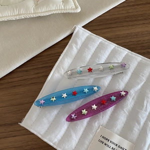 Set of three glitter star hair clips in blue, purple and clear resin for women