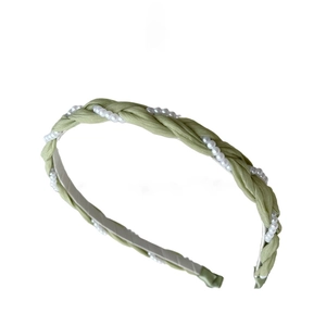 Pale green braided fabric headband with white faux pearls on a clean white background
