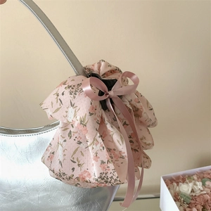Detailed view of pink floral fabric hair claw clip with elegant long silk ribbon streamers